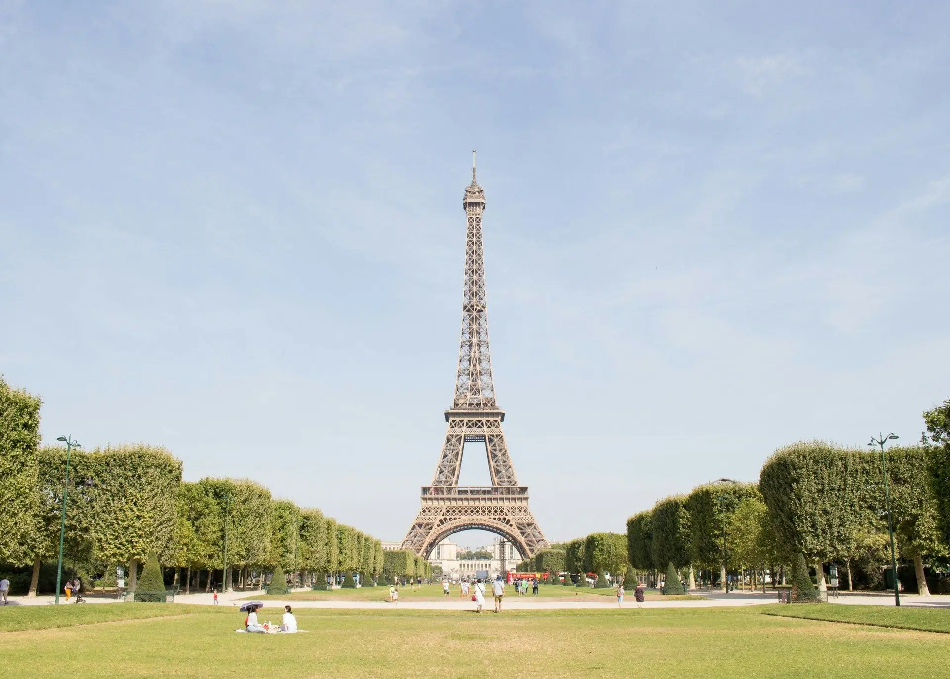 A group of visitors gathered in front of the Eiffel Tower
