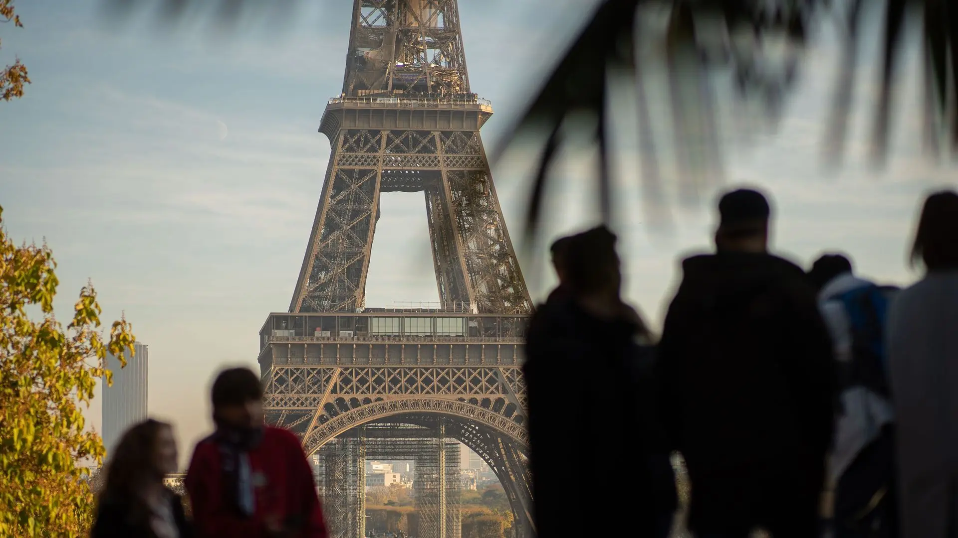 Tourists silhouetted in front of the Eiffel Tower