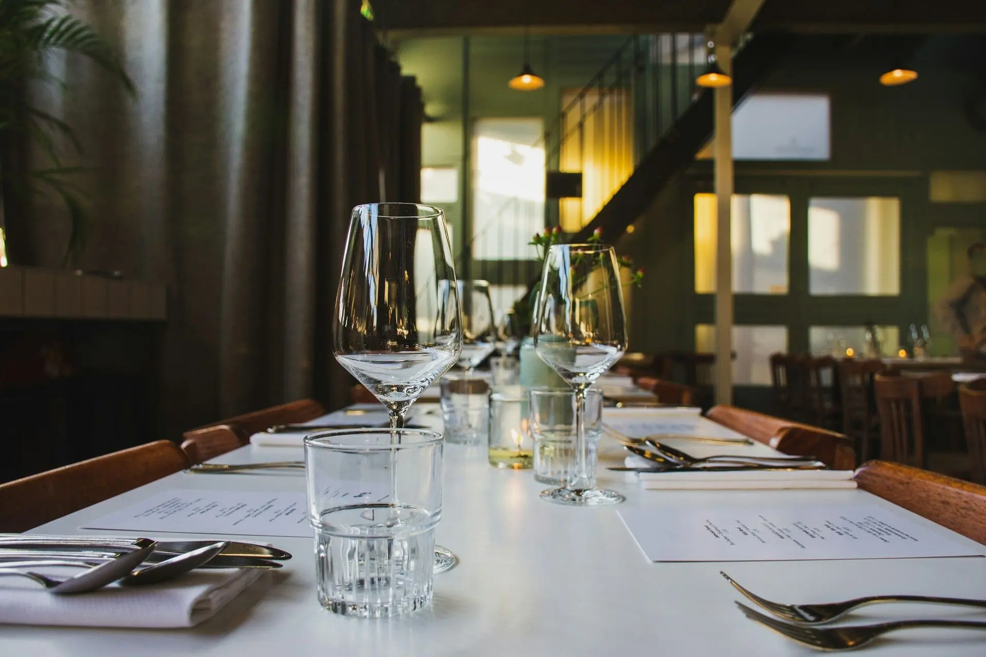 A set dining table with wine glasses in an elegant restaurant