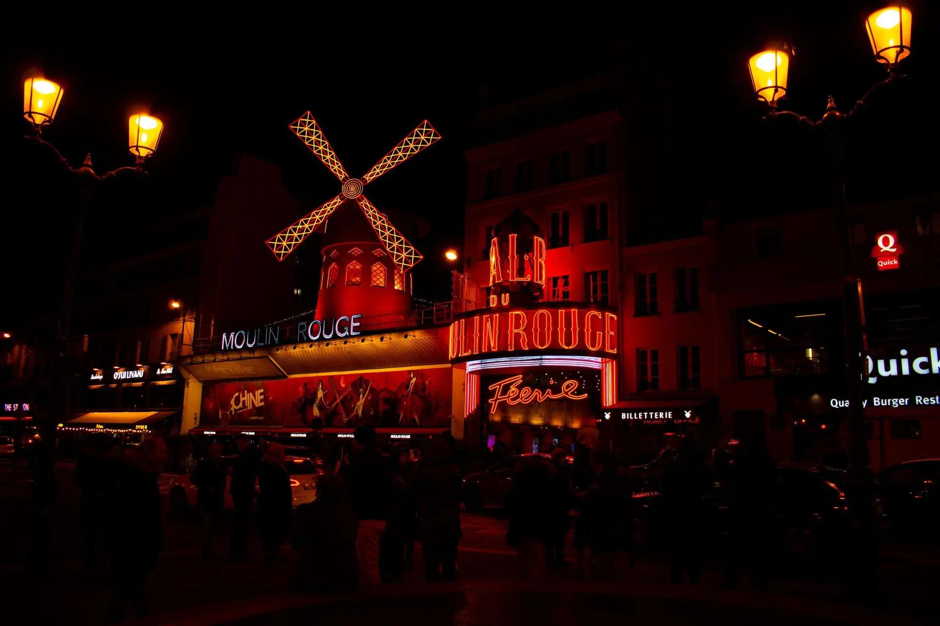 The illuminated Moulin Rouge at night in Paris The illuminated Moulin Rouge at night in Paris